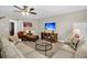 Living room featuring sectional couches, glass coffee table, TV, leather chair and ample natural light at 315 Fish Creek Ct, Summerville, SC 29486