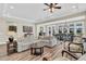 Bright living area with a neutral sectional, wood floors, and a view into the dining space at 315 Fish Creek Ct, Summerville, SC 29486