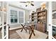 Well-lit office space featuring a large window, wooden desk, and built-in bookshelf at 315 Fish Creek Ct, Summerville, SC 29486
