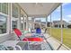 Relaxing screened porch features ceiling fan and stylish outdoor furniture with views of backyard at 315 Fish Creek Ct, Summerville, SC 29486