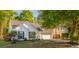Traditional home boasting a manicured lawn, mature trees, and a welcoming two-car garage at 3222 Morningdale Dr, Mount Pleasant, SC 29466