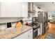 A well-lit kitchen showcasing granite countertops, stainless steel appliances, and tile backsplash at 3222 Morningdale Dr, Mount Pleasant, SC 29466
