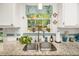 Kitchen sink and granite countertops illuminated by natural light from the window at 3222 Morningdale Dr, Mount Pleasant, SC 29466