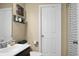 Well-lit bathroom featuring a vanity with a dark wood base, a toilet and a white door at 328 Bradley Bend Dr, Moncks Corner, SC 29461