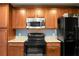 Beautiful kitchen with a new-looking oven, microwave and wooden cabinets at 328 Bradley Bend Dr, Moncks Corner, SC 29461