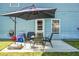 Inviting patio with outdoor dining set, shade umbrella, and view of the backyard at 328 Bradley Bend Dr, Moncks Corner, SC 29461