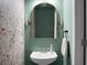 Charming powder room with elegant pedestal sink, sconces, gold mirror and stylish floral wallpaper at 328 Bradley Bend Dr, Moncks Corner, SC 29461