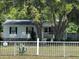 Quaint single story home with white siding and a charming white picket fence at 3342 Habitat Blvd Blvd, Johns Island, SC 29455