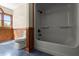 Full bathroom with white shower stall, paneled accent wall, toilet, and tile flooring at 3936 Lodge Hwy, Smoaks, SC 29481