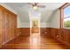 Charming bedroom with wood paneling, hardwood floors, and natural light from the window at 3936 Lodge Hwy, Smoaks, SC 29481