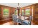 Cozy dining room with wood paneled walls, a chandelier, and views of the outdoors at 3936 Lodge Hwy, Smoaks, SC 29481