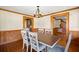 Dining room with wood trim, wainscoting, a chandelier, and views to the hallway and kitchen at 3936 Lodge Hwy, Smoaks, SC 29481