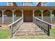 Inviting front entrance with stone steps, wooden porch, and a sturdy wooden door at 3936 Lodge Hwy, Smoaks, SC 29481