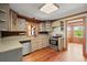 Galley kitchen featuring wood floors, modern appliances, and a window overlooking the backyard at 3936 Lodge Hwy, Smoaks, SC 29481