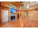 Bright living room featuring wood walls, a stone fireplace, and an open floor plan to the second level at 3936 Lodge Hwy, Smoaks, SC 29481