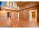 Spacious living room with hardwood floors, wood paneled walls, and an open balcony above at 3936 Lodge Hwy, Smoaks, SC 29481