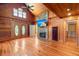 Living room with a stone fireplace, hardwood floors, and wooden walls at 3936 Lodge Hwy, Smoaks, SC 29481