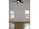 Cozy bedroom featuring hardwood floors, bright windows and a ceiling fan for comfort at 4153 Hickory Ln, Ladson, SC 29456