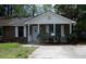 Charming one-story brick home with a cozy front porch and a well-maintained lawn at 4153 Hickory Ln, Ladson, SC 29456