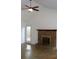 Spacious living room boasts a brick fireplace, ceiling fan, and access to the backyard at 4153 Hickory Ln, Ladson, SC 29456