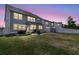 The backyard at dusk features cozy seating, a patio, and lush green grass at 427 W Respite Ln, Summerville, SC 29483