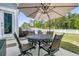 Outdoor dining area with a round table under an umbrella, set in a backyard at 427 W Respite Ln, Summerville, SC 29483