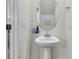Elegant pedestal sink with oval mirror in a well-lit half bathroom at 427 W Respite Ln, Summerville, SC 29483