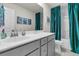 Well-lit bathroom featuring a single sink vanity and vibrant teal shower curtain at 427 W Respite Ln, Summerville, SC 29483