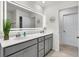 Bright bathroom featuring a dual sink vanity, illuminated mirror, and coastal decor at 427 W Respite Ln, Summerville, SC 29483