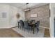 Stylish dining room featuring a brick accent wall, modern lighting, and elegant decor at 427 W Respite Ln, Summerville, SC 29483