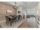 Elegant dining room with brick accent wall, stylish lighting, and modern decor open to the living area at 427 W Respite Ln, Summerville, SC 29483