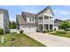 Charming two-story home with a covered porch, garage, and beautifully landscaped front yard at 427 W Respite Ln, Summerville, SC 29483