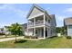 Charming two-story home with a covered porch, garage, and landscaped front yard at 427 W Respite Ln, Summerville, SC 29483