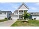 Charming two-story home with a welcoming front porch and well-maintained lawn in a suburban neighborhood at 427 W Respite Ln, Summerville, SC 29483