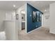 Upstairs hallway with neutral carpet and teal accent wall with framed art at 427 W Respite Ln, Summerville, SC 29483
