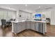 Open-concept kitchen featuring a large island, stainless steel appliances, and hardwood floors at 427 W Respite Ln, Summerville, SC 29483
