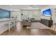 Open-concept living room featuring large windows, modern furnishings, and a seamless flow to the kitchen at 427 W Respite Ln, Summerville, SC 29483