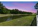 Scenic pond view surrounded by lush greenery, offering a peaceful natural setting at 427 W Respite Ln, Summerville, SC 29483