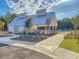 Modern pool house with a metallic roof surrounded by plants, a fence, and a walkway at 427 W Respite Ln, Summerville, SC 29483