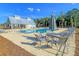Community pool with lounge chairs, umbrellas, and tables, set against a backdrop of trees and blue sky at 427 W Respite Ln, Summerville, SC 29483