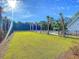 Expansive green space with palm trees leading to a community pool, providing a serene and luxurious ambiance at 427 W Respite Ln, Summerville, SC 29483