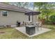 Back patio with a fire pit and outdoor grill. Perfect for entertaining guests at 4709 Marlboro Pl, North Charleston, SC 29405