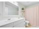This modern bathroom features a double sink vanity, framed mirror, and shower-tub combination, perfect for comfort at 4709 Marlboro Pl, North Charleston, SC 29405