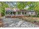 Charming single-story home with neutral siding, dark shutters, and a cozy front porch at 4709 Marlboro Pl, North Charleston, SC 29405