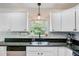 Bright kitchen with white cabinets, stainless steel appliances, and elegant countertops at 4709 Marlboro Pl, North Charleston, SC 29405