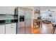 This kitchen features stainless steel appliances, white cabinets and is open to the living room at 4709 Marlboro Pl, North Charleston, SC 29405