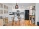 Charming kitchen features white cabinets, stainless appliances and adjacent dining area at 4709 Marlboro Pl, North Charleston, SC 29405