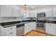 Modern kitchen featuring white cabinets, stainless steel appliances, and dark countertops at 4709 Marlboro Pl, North Charleston, SC 29405