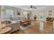 Spacious living room with hardwood floors, gray sectional sofa, and bright natural light at 4709 Marlboro Pl, North Charleston, SC 29405