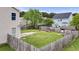 Fenced backyard offers lush greenery, storage shed, and patio space at 4747 Lewis And Clark Trl, Summerville, SC 29485